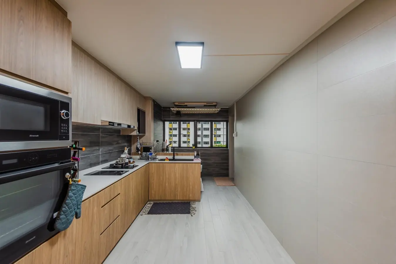 Woodgrain galley kitchen with integrated appliance storage