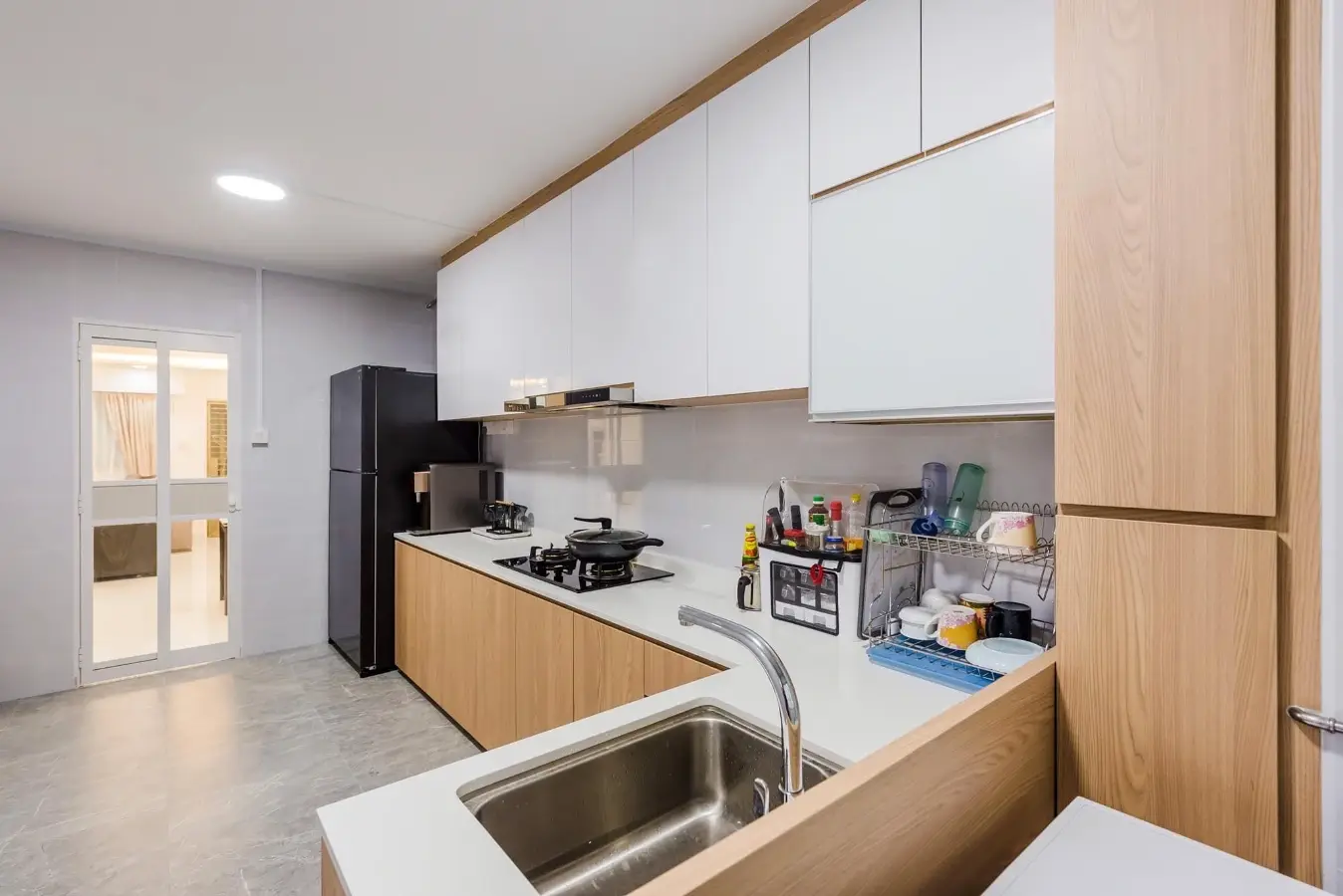 White and oak kitchen cabinetry with peninsula sink