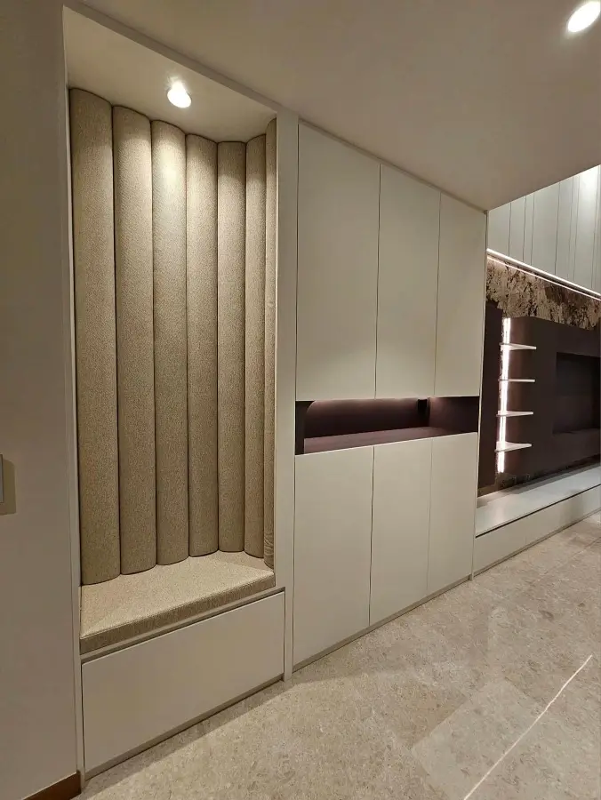 Custom upholstered entry niche and full-height storage