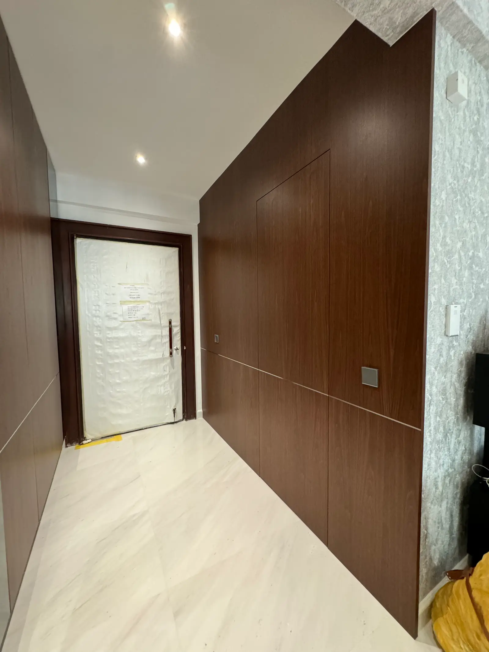 Concealed walnut entrance panels with integrated door