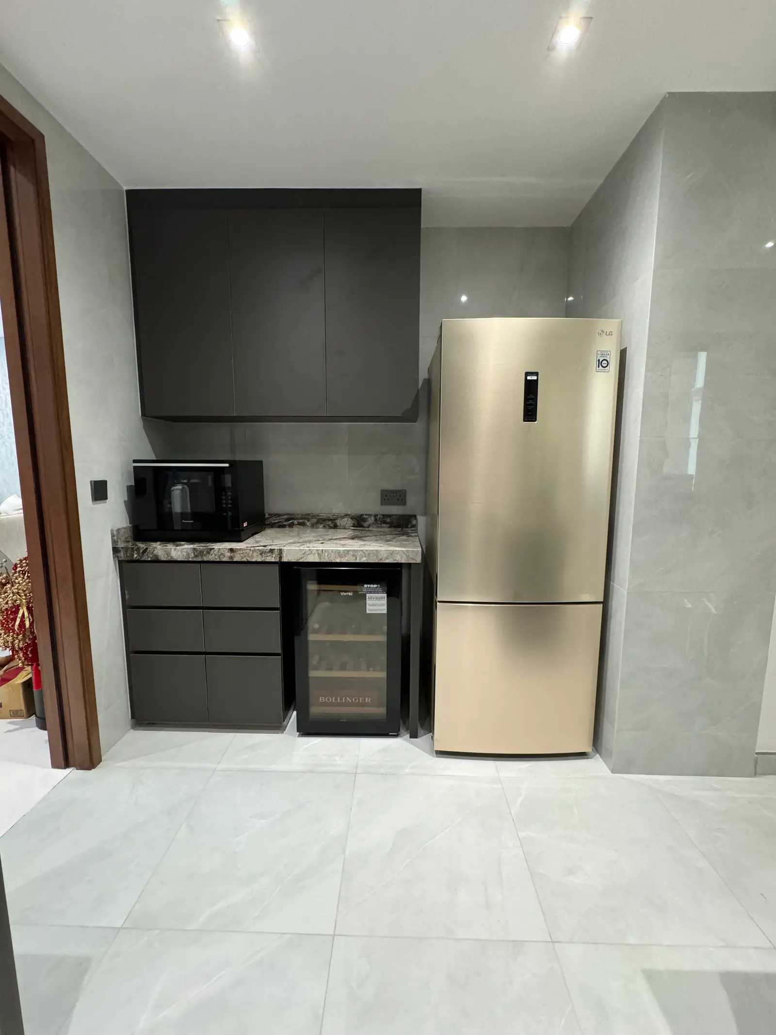Compact dark pantry cabinetry fitted around appliances