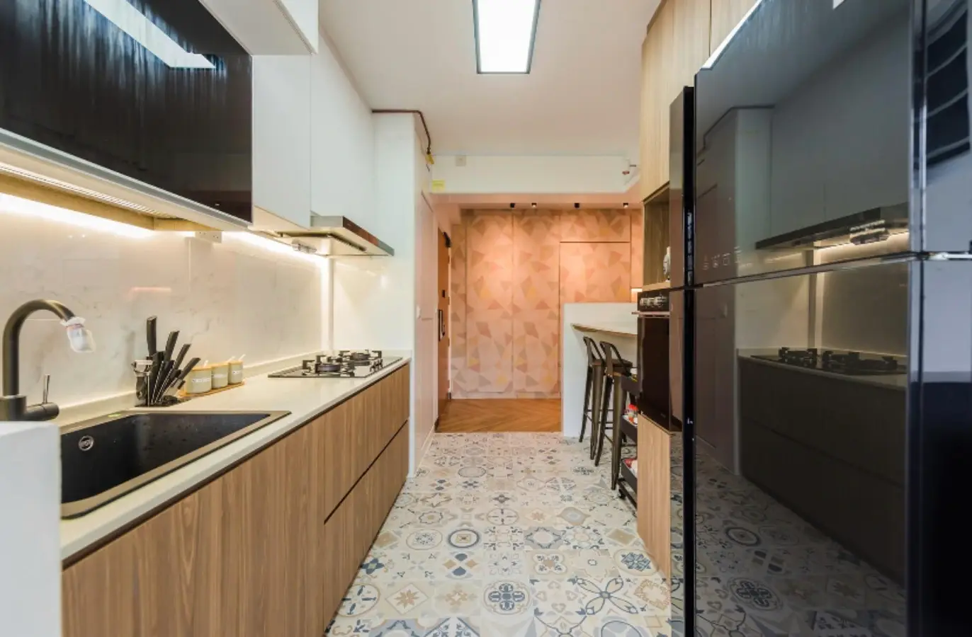 Galley kitchen with woodgrain cabinetry and breakfast counter