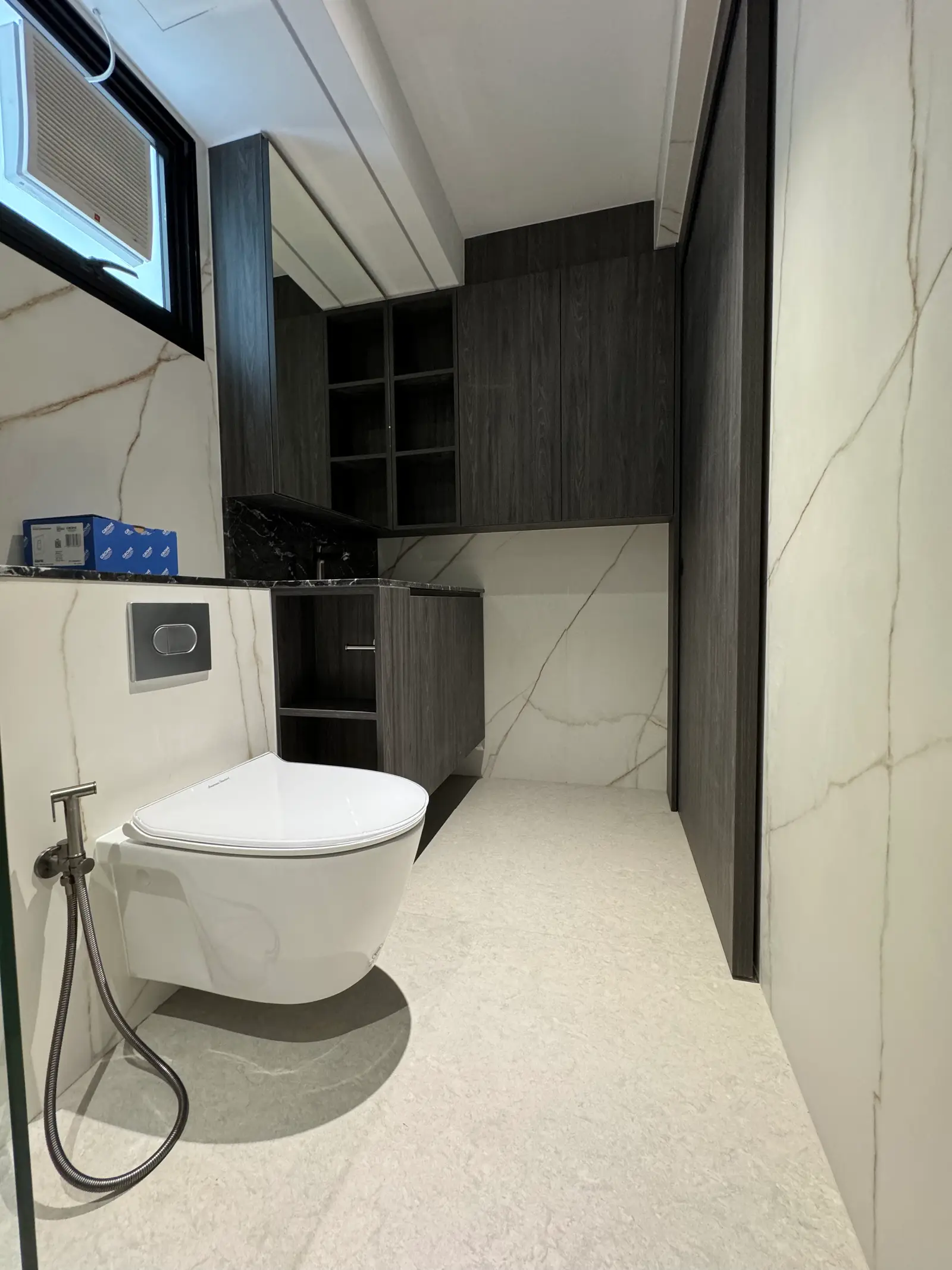 Dark wood bathroom cabinetry coordinated with stone surfaces