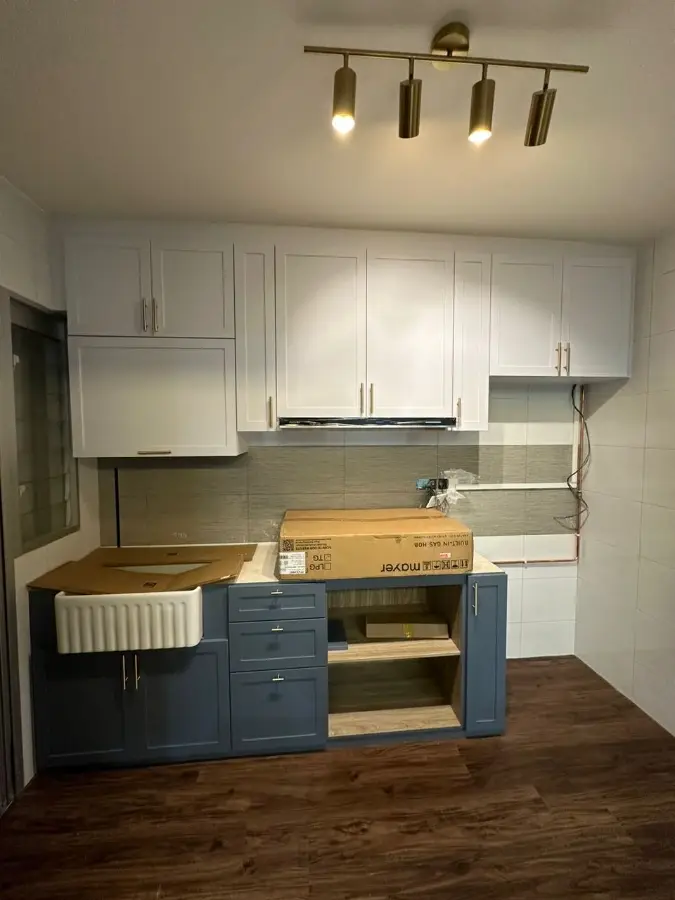 Two-tone shaker cabinetry with farmhouse sink